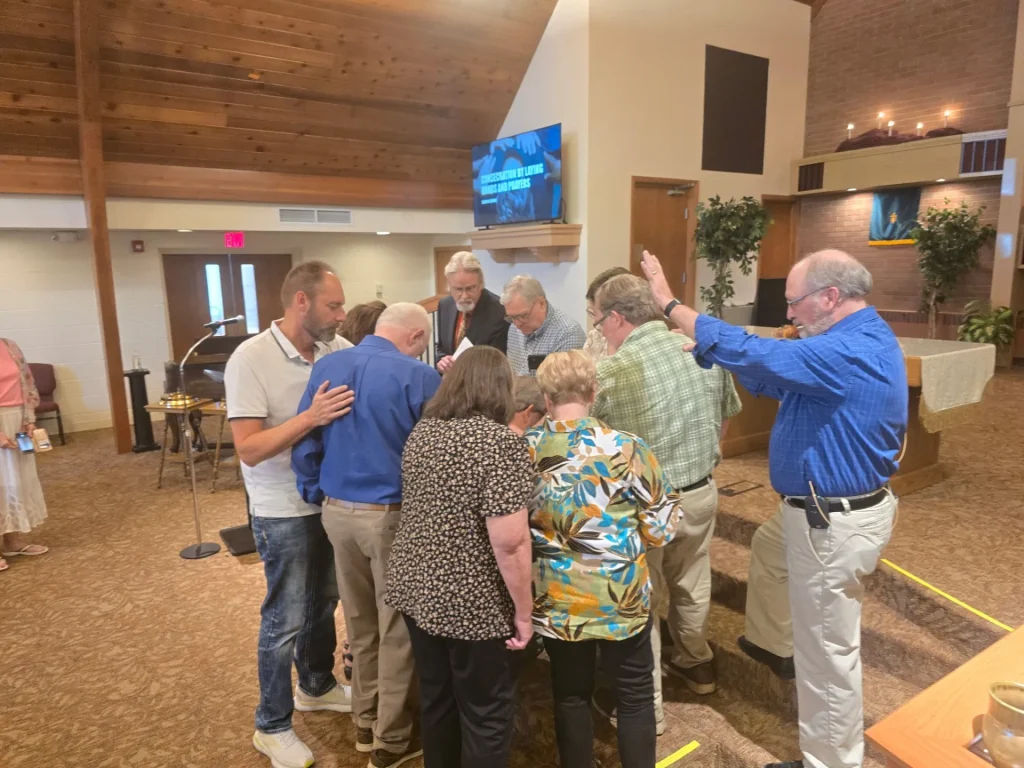 Elders praying together in the King Road sanctuary